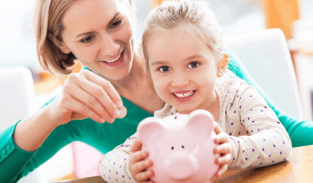 woman and child putting money in piggy bank