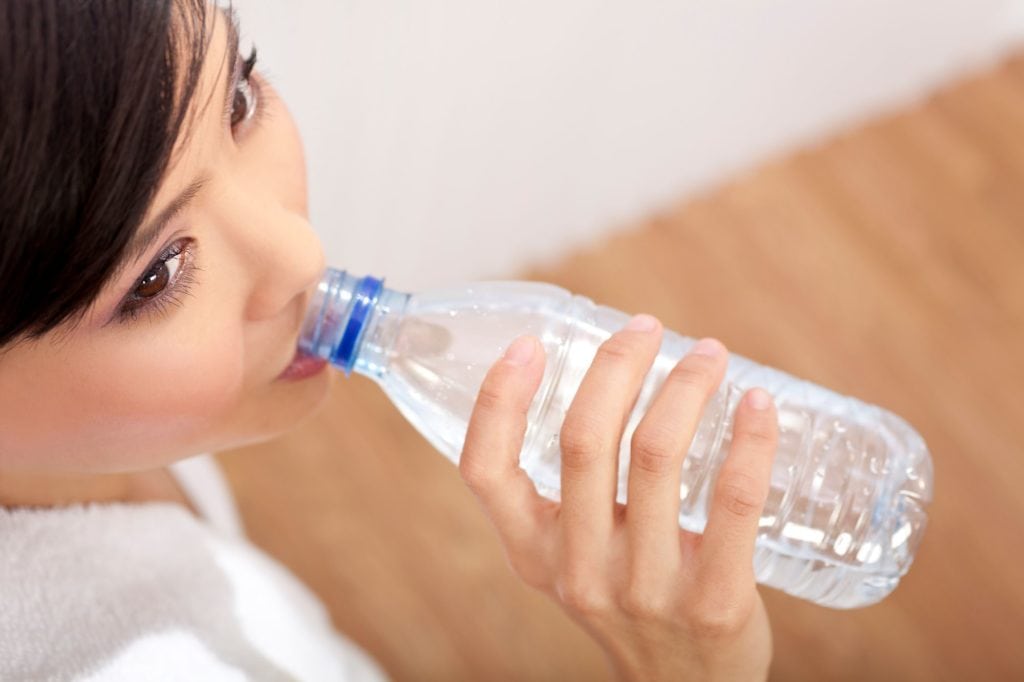 Asian Chinese Girl Drinking Bottle Of Pure Water