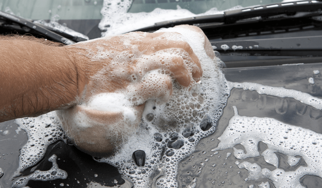 man washing car for extra money