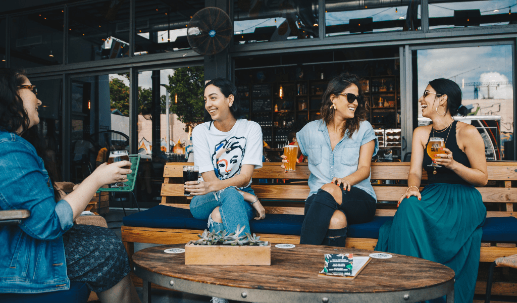 four female friends at a bar