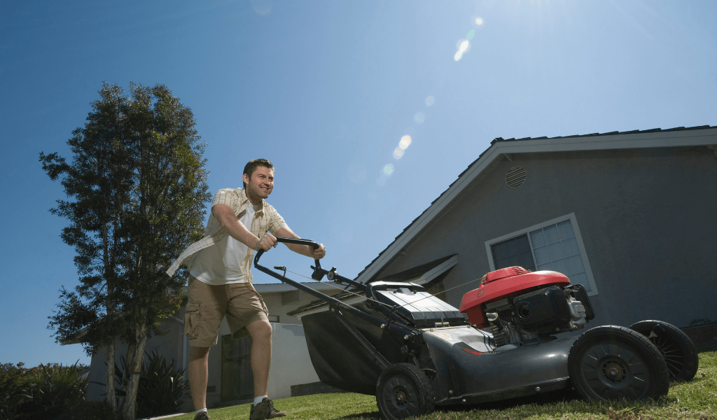 man mowing yards as a side  hustle
