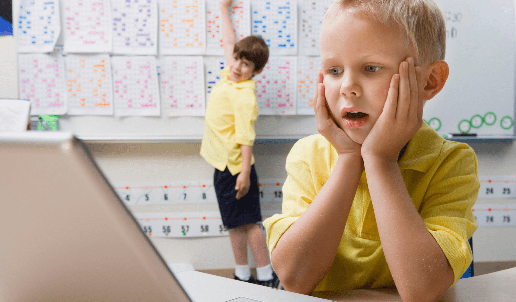 young boy looking shocked at laptop