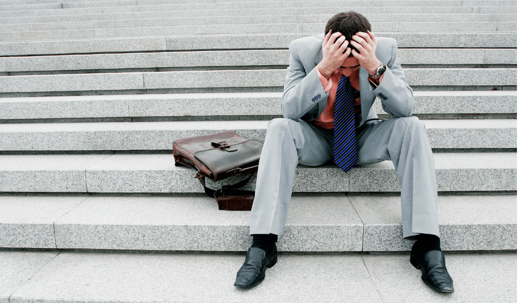 man depressed about losing on investments