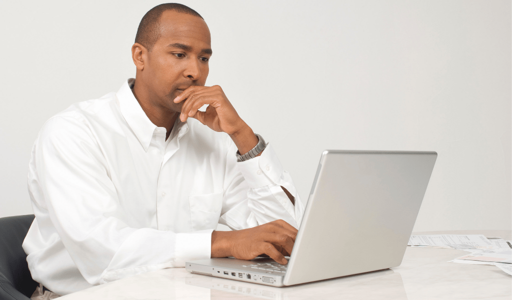 man researching investments on a computer