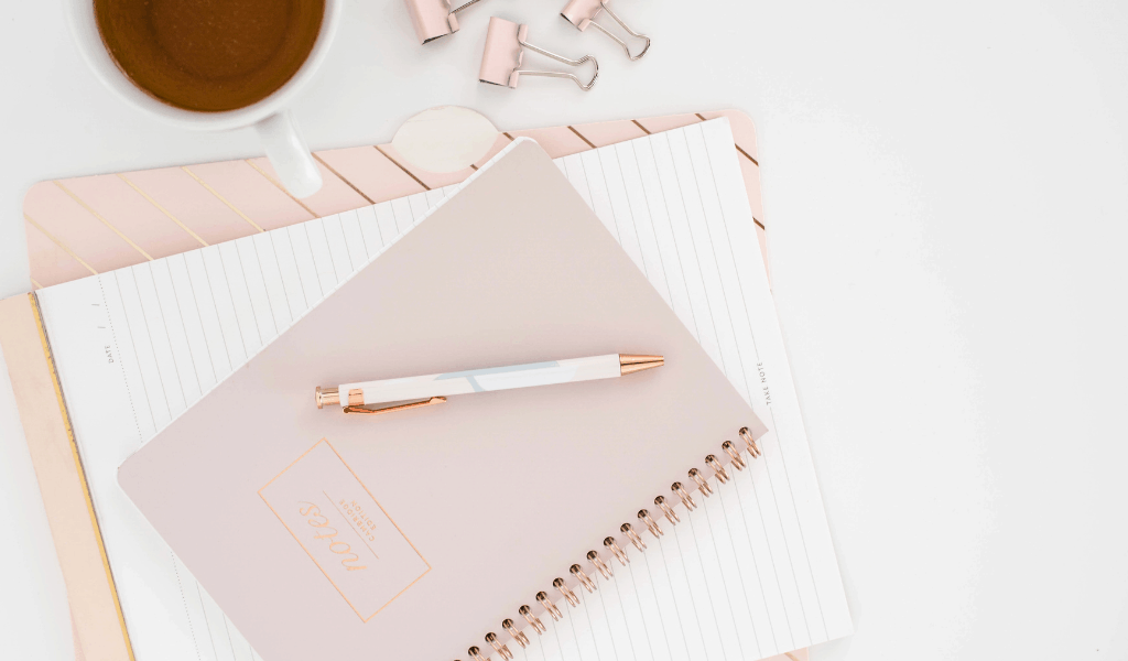 notebook and coffee on table