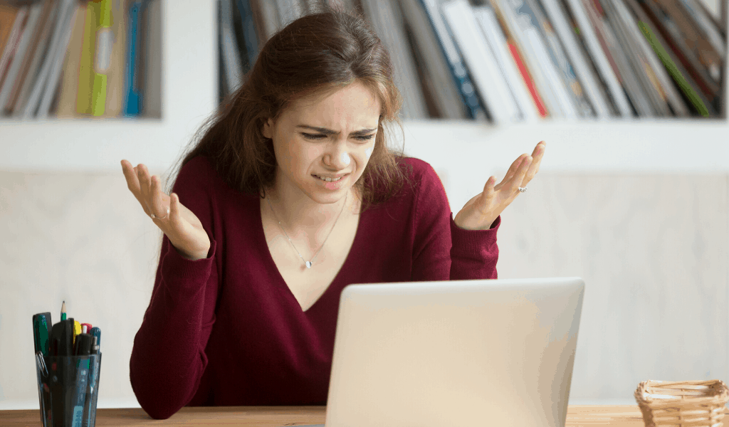 frustrated woman looking at a laptop