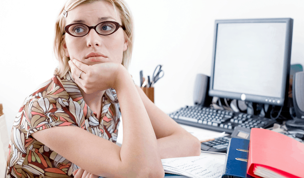 working woman worrying at her desk about a recession