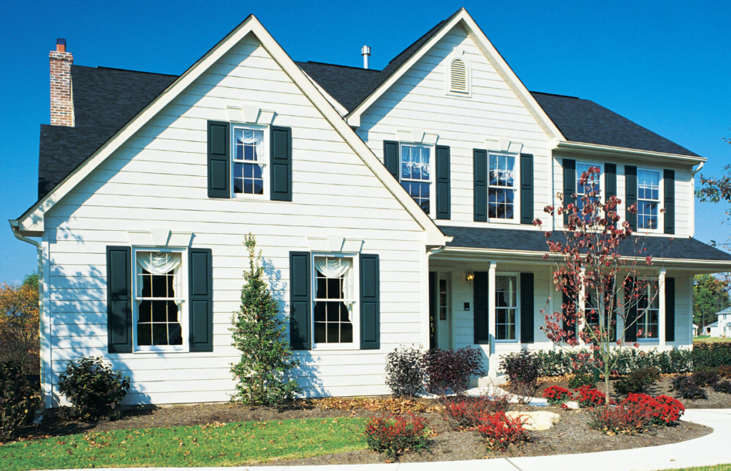 A white cottage style house with blue shutters