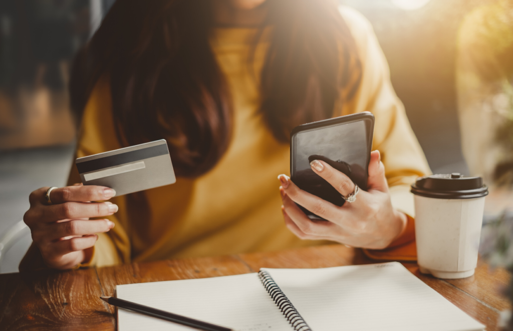 woman holding phone and credit card