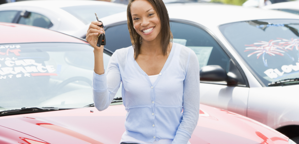 buying a new car is a money myth that can cost you thousands! Black female holding the keys to a new car