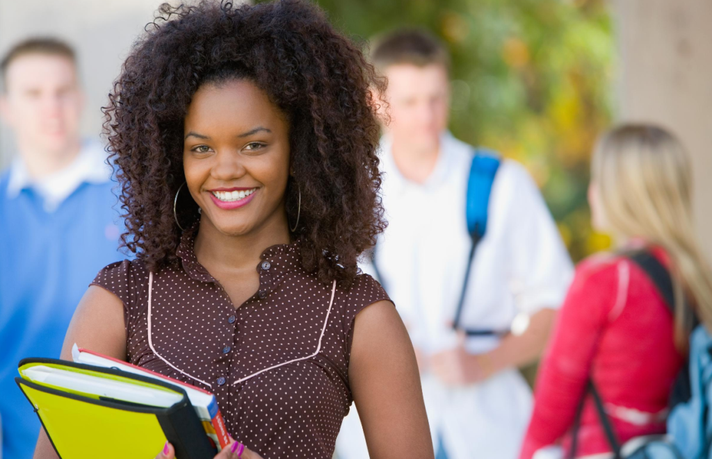 black female college student holding books