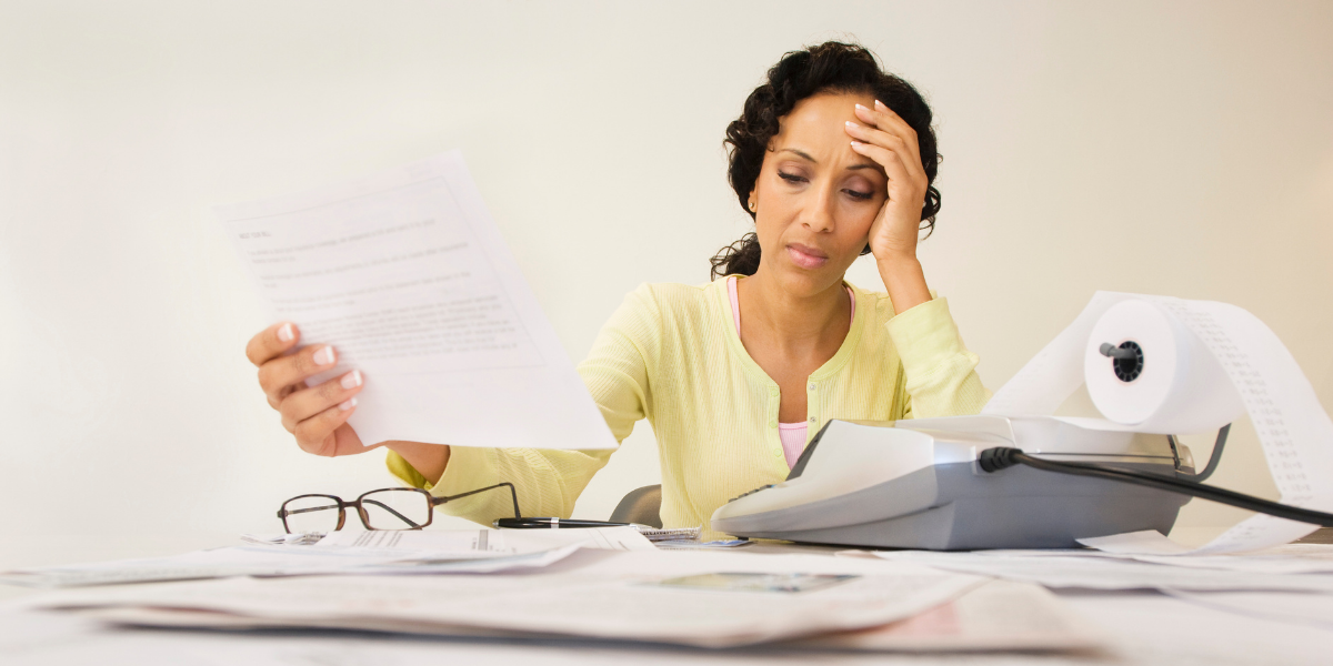 Women stressed looking over budget and calculating expenses