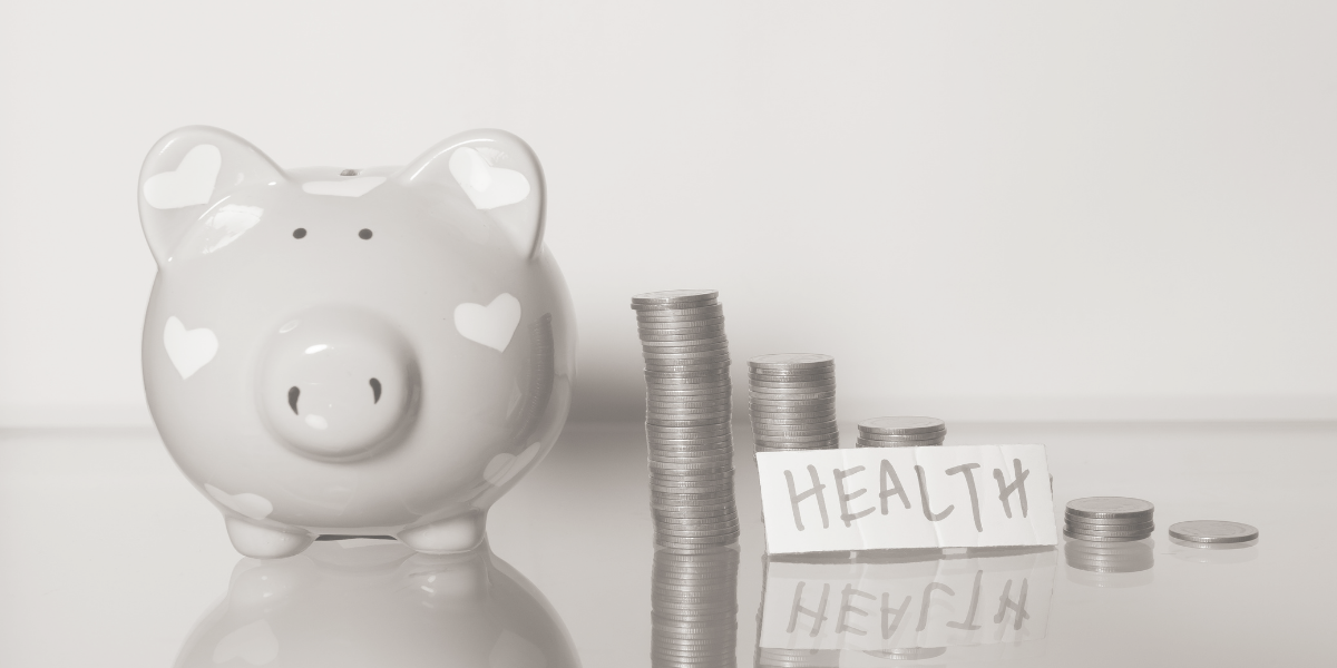 Piggy bank with coins stacked next to it and a note that says HEALTH