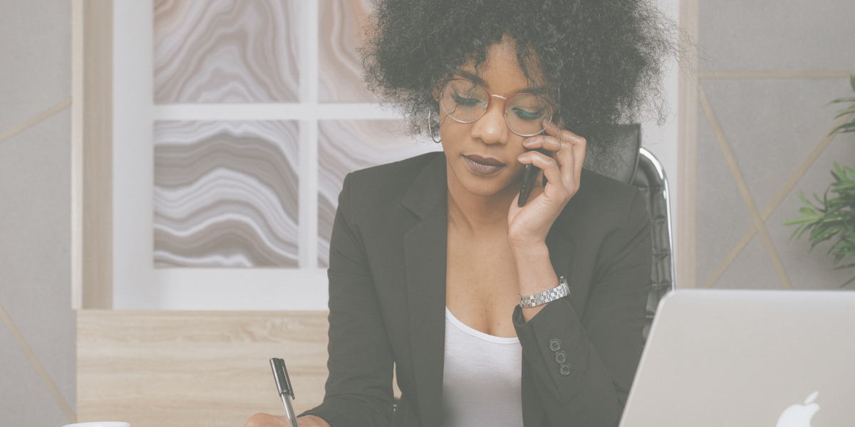 Black women on the phone taking notes