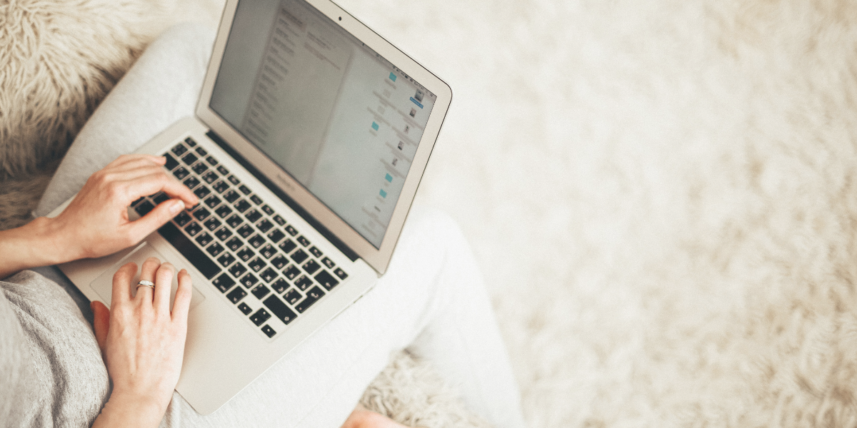 Female sitting in fluffy chair working on her laptop