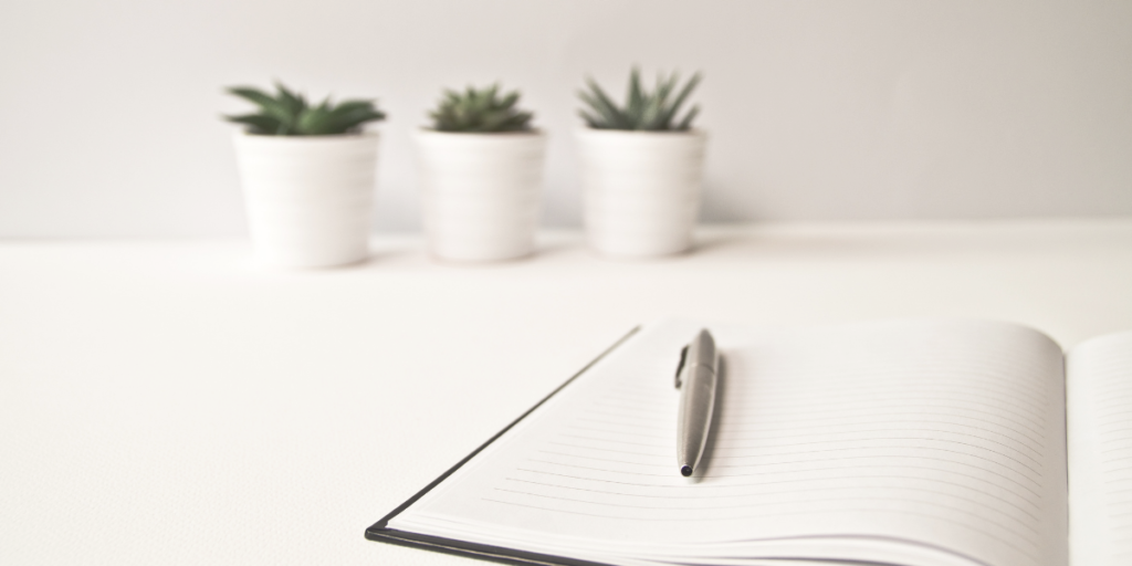 White table with a blank notebook 