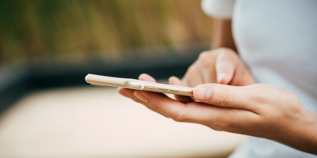 Female searching for free internet on a rose gold cellphone.