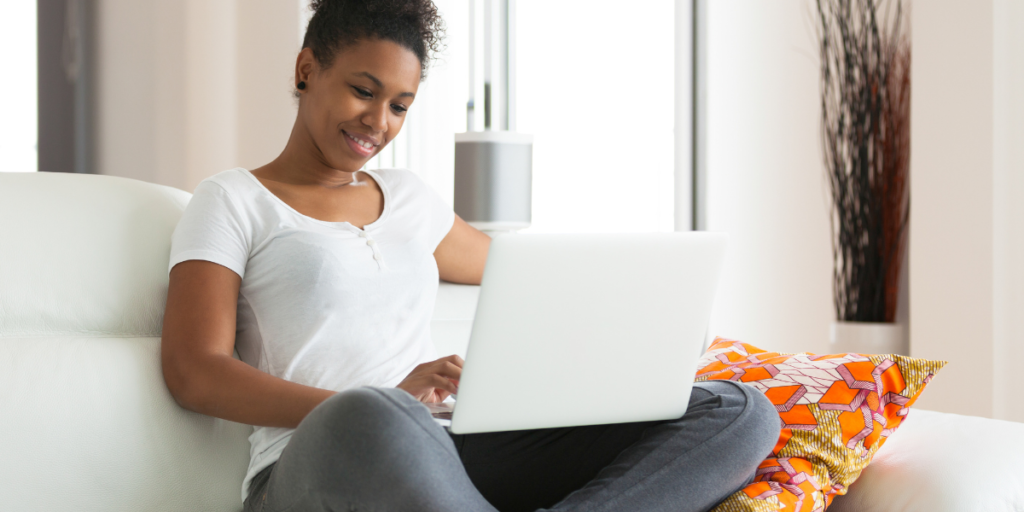 African-American female searching for free internet options on a laptop.