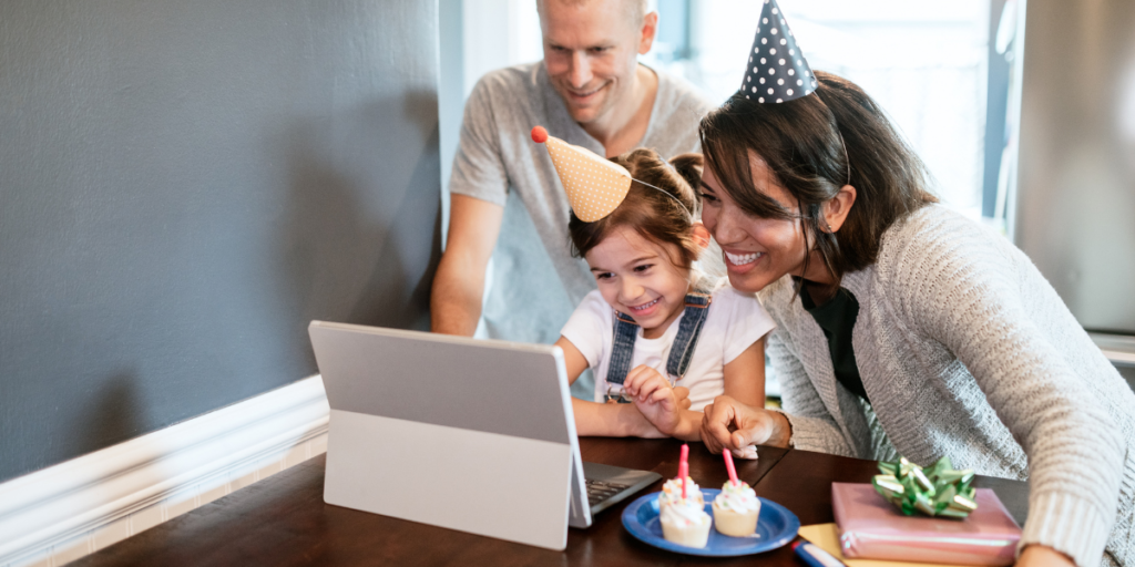 mom dad and daughter having a virtual birthday party using free internet