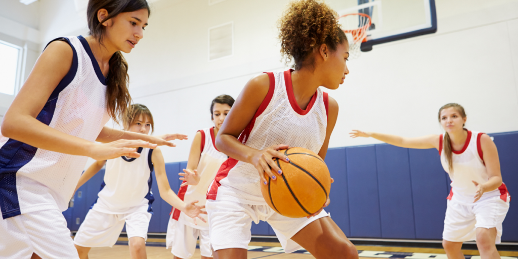 A group of girls playing basketball that their parents had to stick to a budget in order to pay their registration fees to play. 