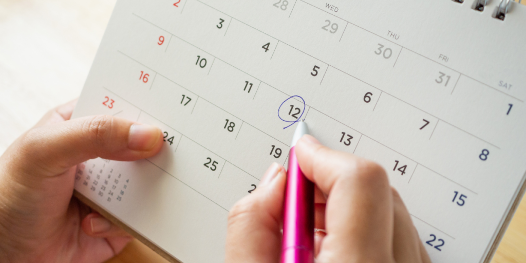 A calendar with the 12th being circled in pen reviewing and sticking to their budget. 