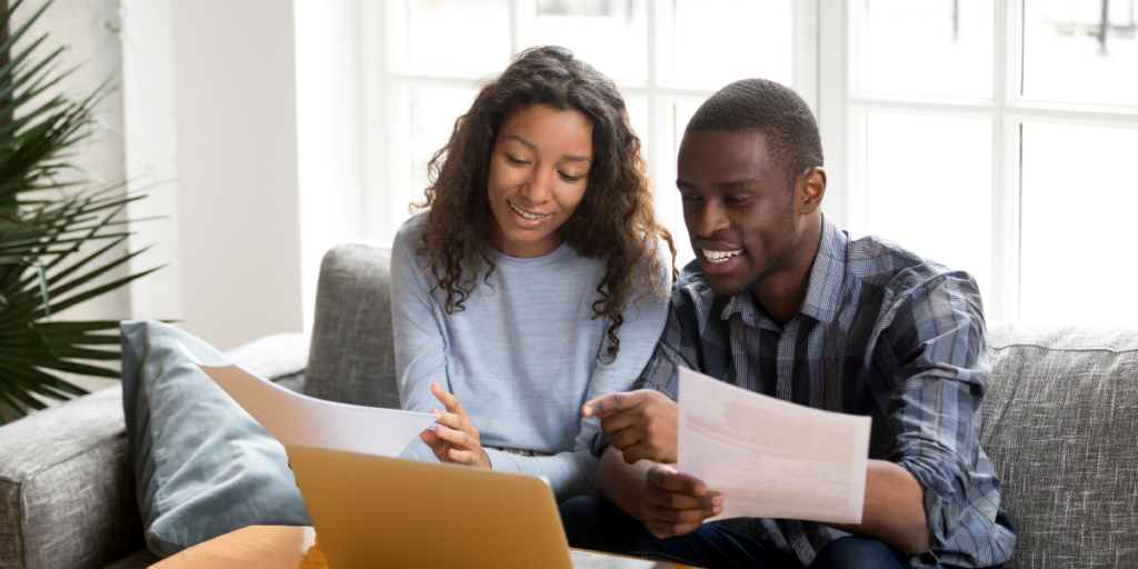 A male and female couple reviewing their budget and discussing how to become millionaires. 