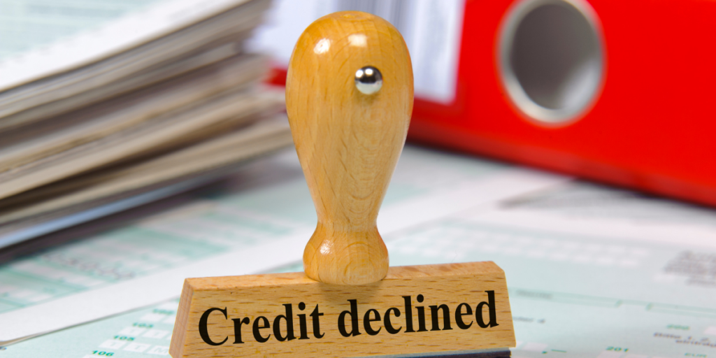 An ink stamp labeled credit declined reminding one why they should stick to their budget. 