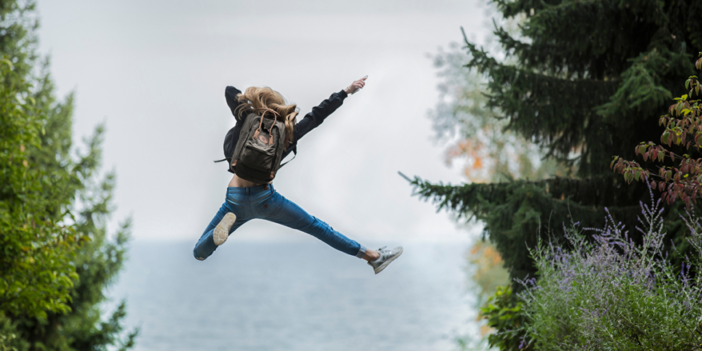 Someone jumping for joy because they have been able to stick to their budget. 