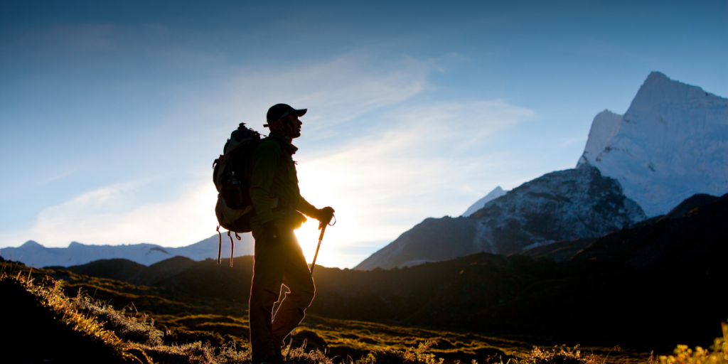 A guy on a hiking trip in the mountains because he was able to stick to his budget and afford to take the trip. 