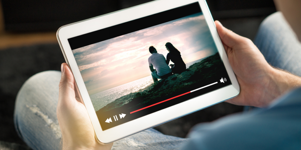 Person watching free movies online using a tablet.