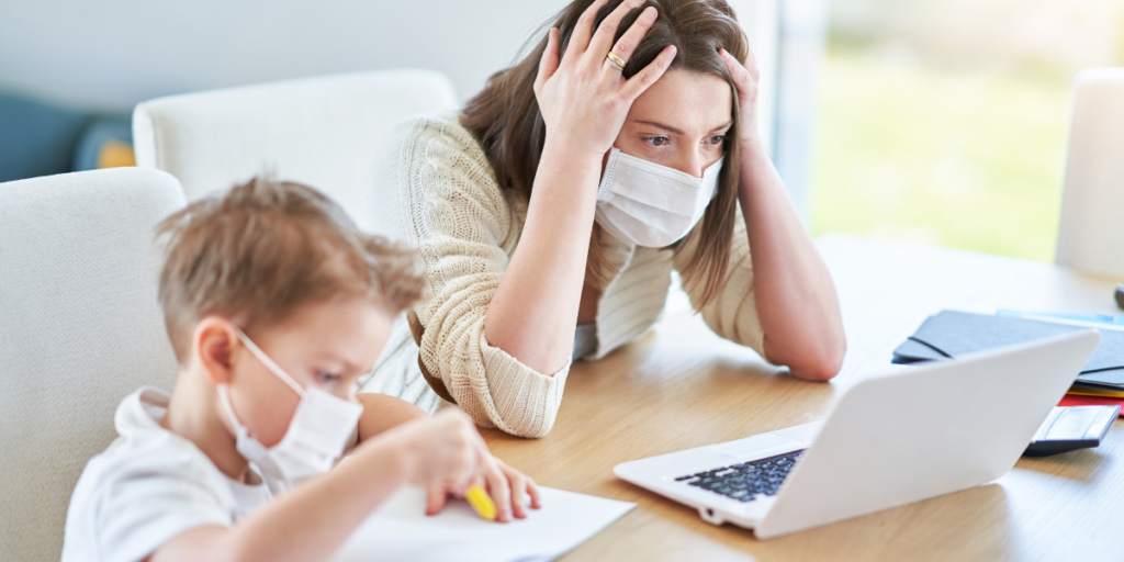 Two people wearing masks searching for free movies online during the pandemic. 