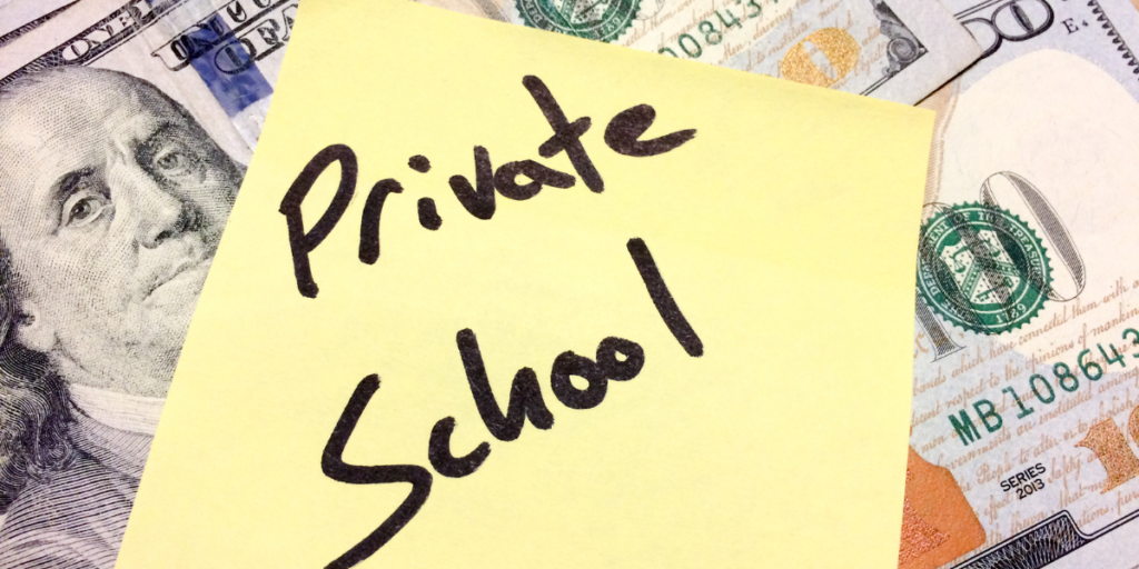 American money under a yellow post it note labeled "private school" reminding one to stick to their budget in order to afford a private school. 