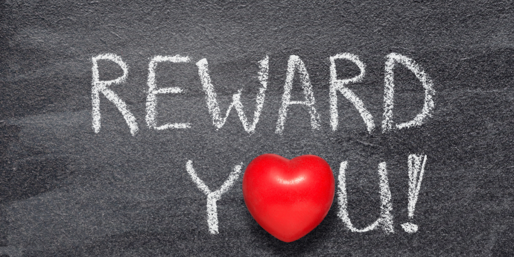 Reward you written in chalk with a red heart as the letter O in the word You.  When you stick to your budget you can reward yourself. 