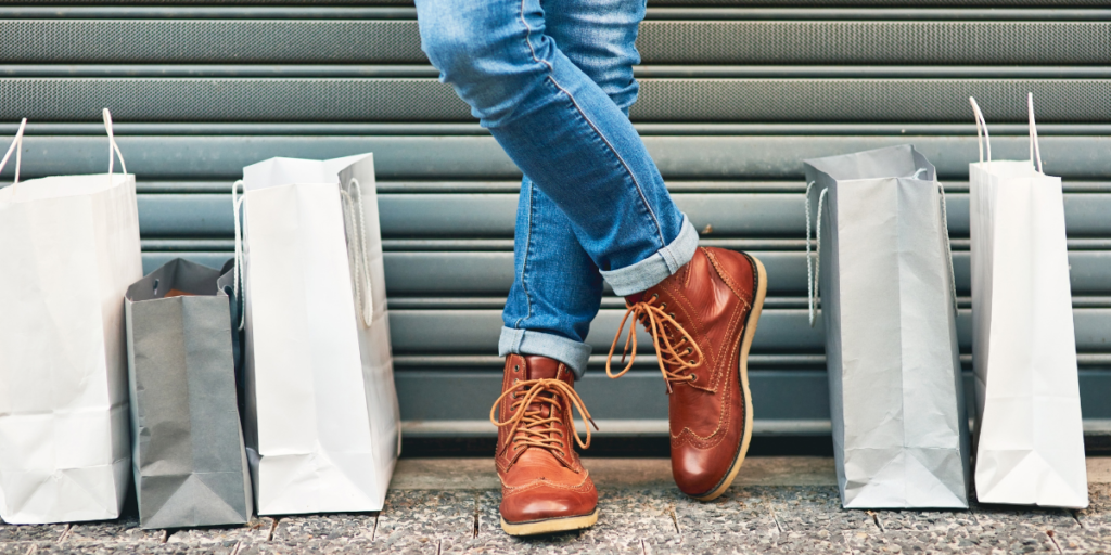 A person's standing with shopping bags to each side of their feet wondering if they were able to stick to their budget.  