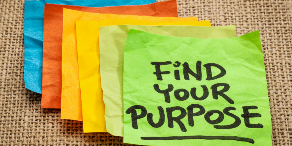 Several colorful post-it notes laying on burlap with the top one showing Find Your Purpose and in turn that will help one stay motivated. 