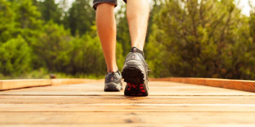 A person taking a walk because a lack of physical movement can keep hinder one from staying motivated.  