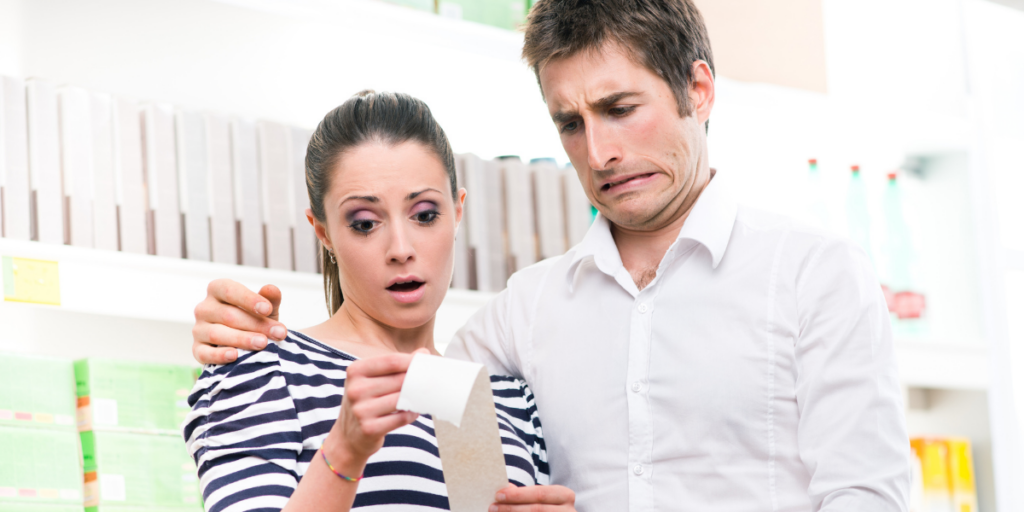 Couple reviewing the receipt for their dreaded grocery budget purchases. 