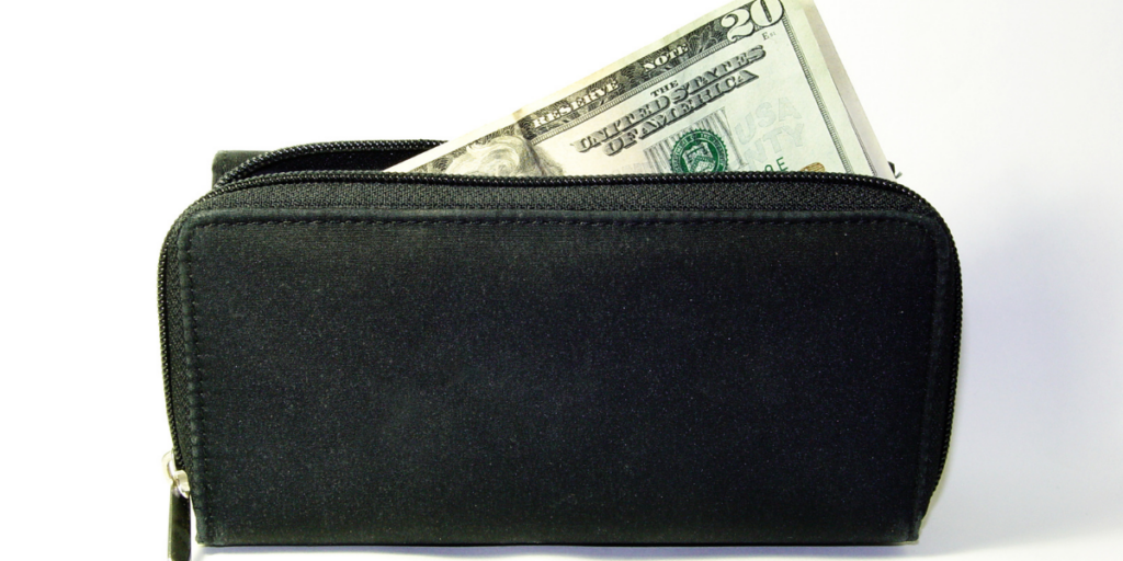 A black wallet with money sticking out. 