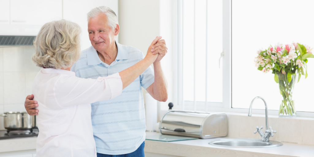 A seasoned couple enjoying a dance in their kitchen can be a nice starter for a date night out or in. 