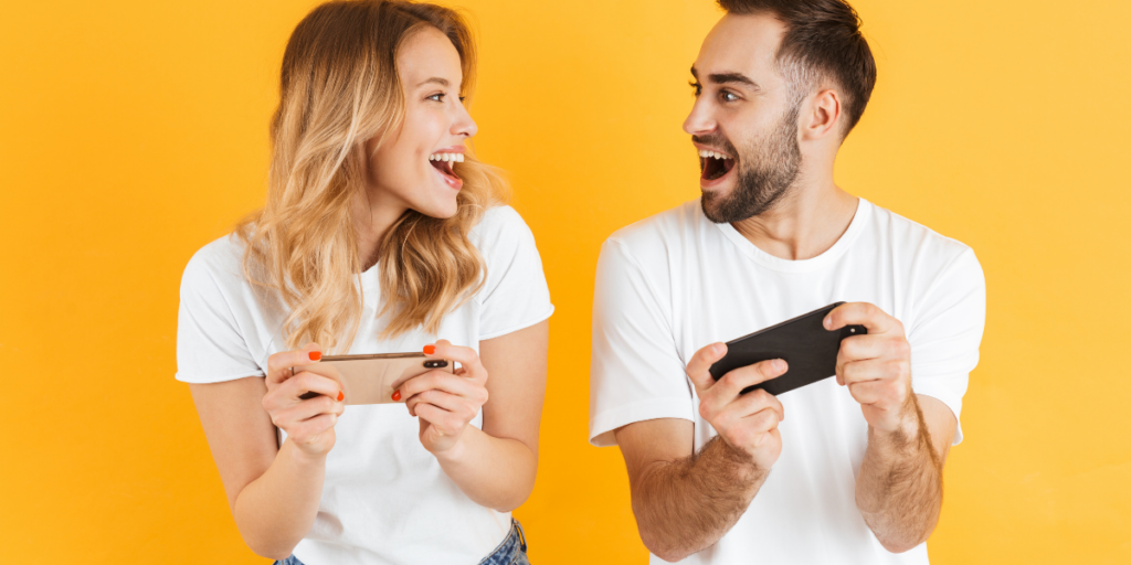 A couple earning gift cards online by playing app games on their phone. 