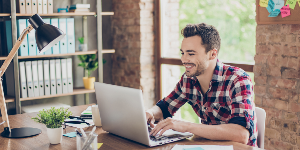 A guy with his laptop working from home as a part-time freelancer over the summer. 