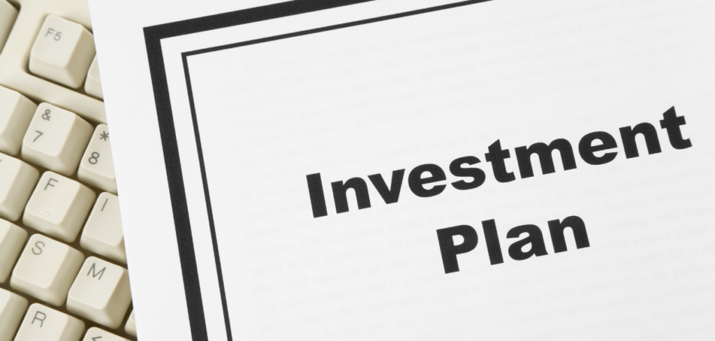an investment plan and a white keyboard
