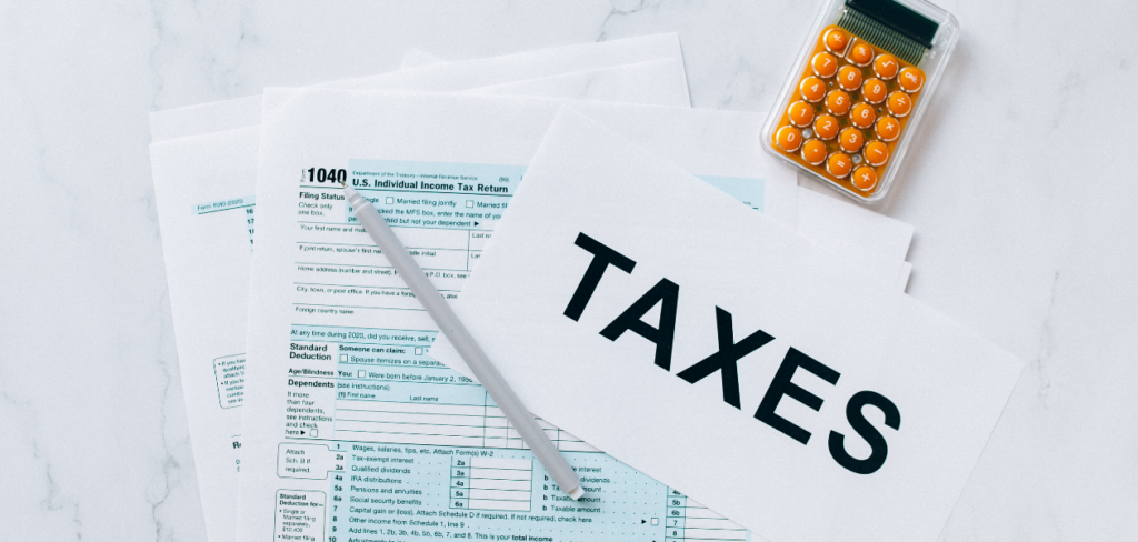 Income tax return form with a yellow calculator and gray pen