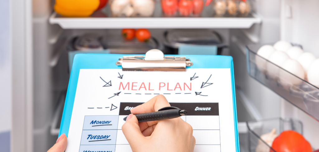 Woman making a meal plan in the kitchen