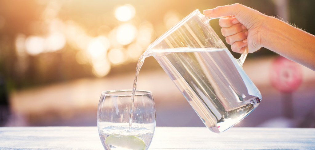 Pouring water from pitcher into glass