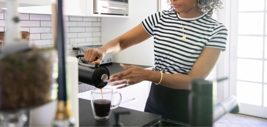  A woman making coffee at home.