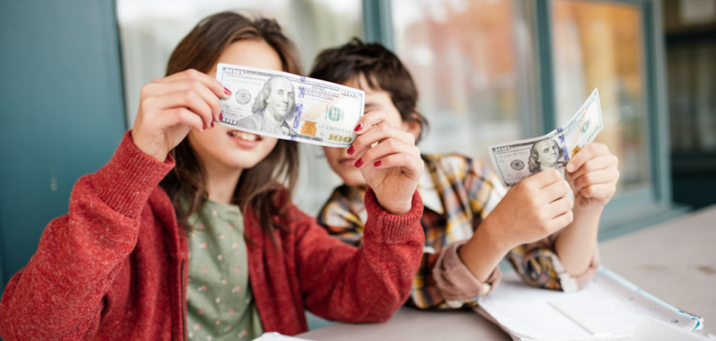 A woman teaching a kid about money.