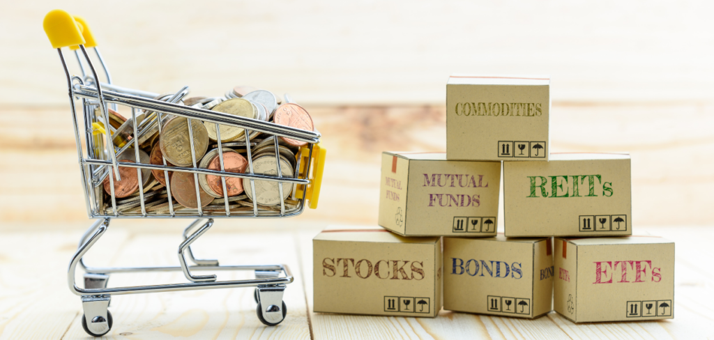 A mini shopping cart with coins and paper boxes of financial instruments like Mutual funds, Bonds, Stocks, REITs, ETF's and Commodities.