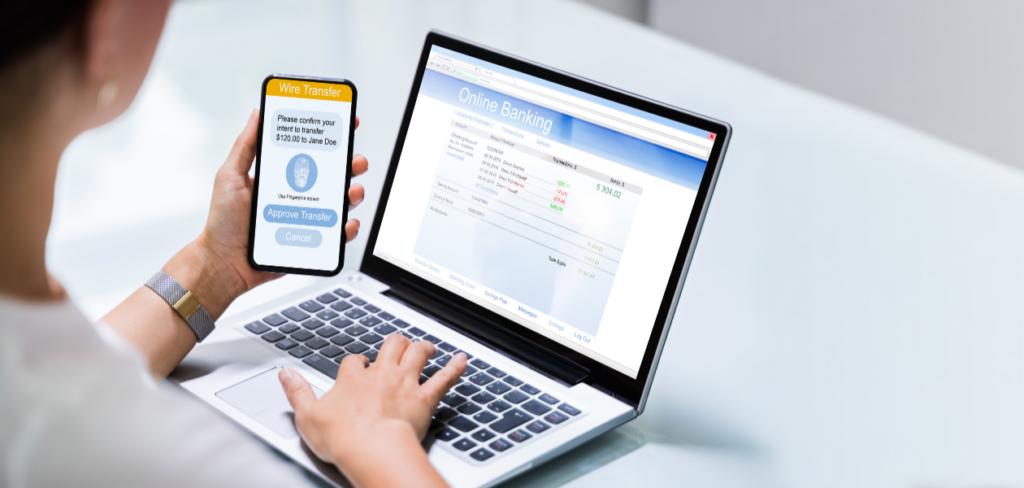 Online banking business app on mobile phone and laptop.