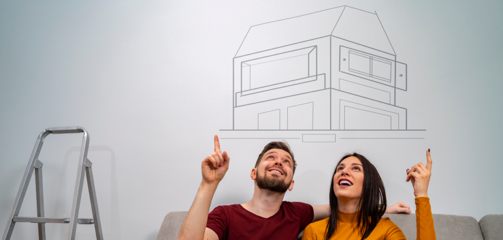 A man and a woman sitting on a sofa, dreaming about a new home.